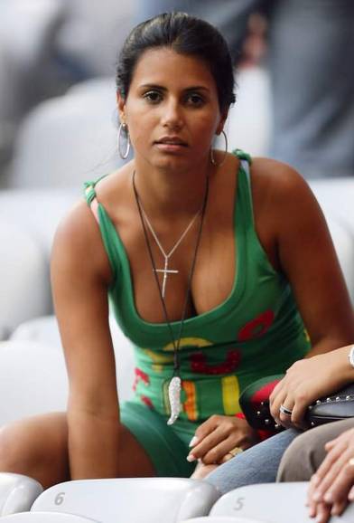Cleavage of a football cheerleader decorated with a cross.